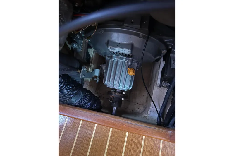 Slide: The Image of Engine compartment of a 2004 Hunter 386 sailboat, showcasing mechanical components. - 24