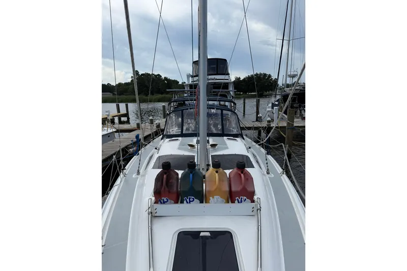 Slide: The Image of 2004 Hunter 386 sailboat docked with fuel containers on deck. - 29