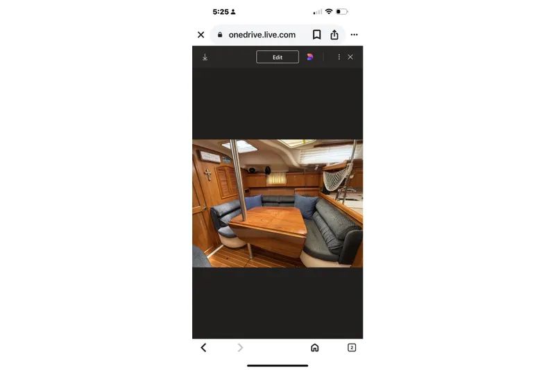 Slide: The Image of Interior of 2004 Hunter 386 sailboat with wooden dining area and cushioned seating. - 31