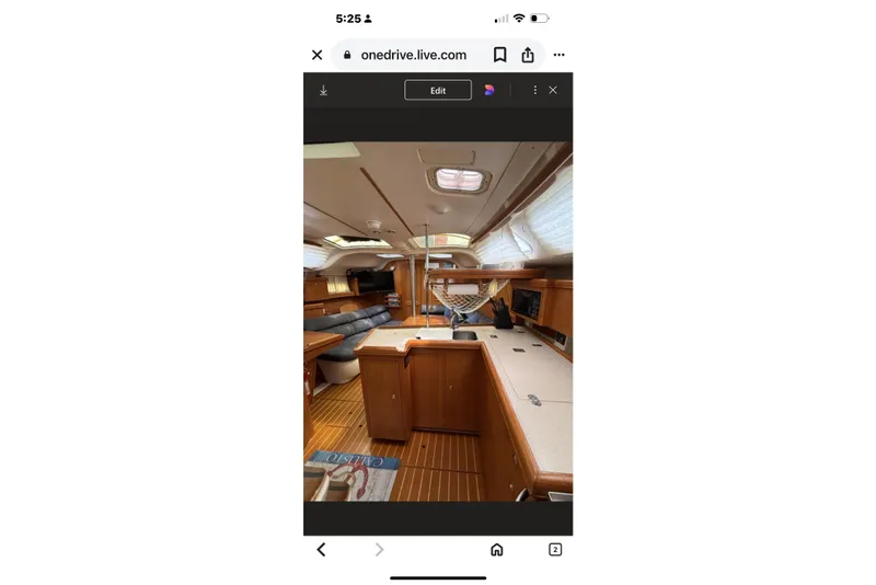 Slide: The Image of Interior of a 2004 Hunter 386 sailboat, featuring wood finishes and spacious layout. - 32