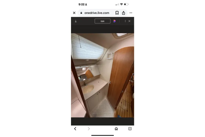 Slide: The Image of Interior of 2004 Hunter 386 sailboat bathroom with sink and wooden door. - 35