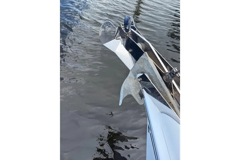 Slide: The Image of Bow of 2004 Hunter 386 sailboat with anchor over water. - 6