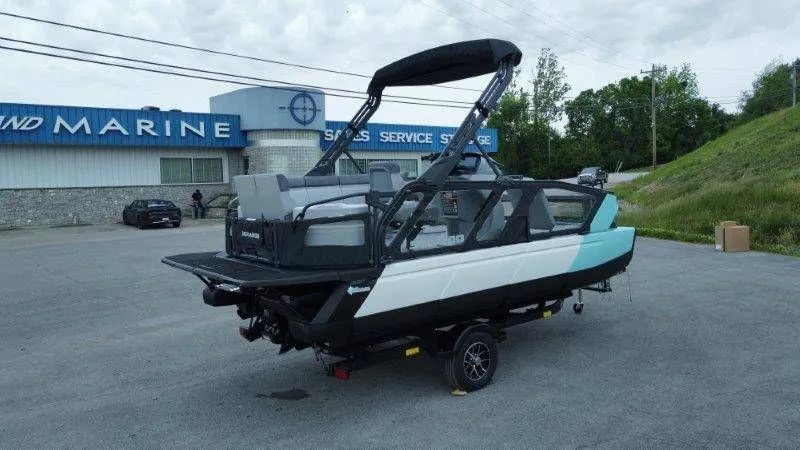 Slide: The Image of 2026 Sea-Doo Switch Sport 18 pontoon boat in parking lot outside marine shop. - 20