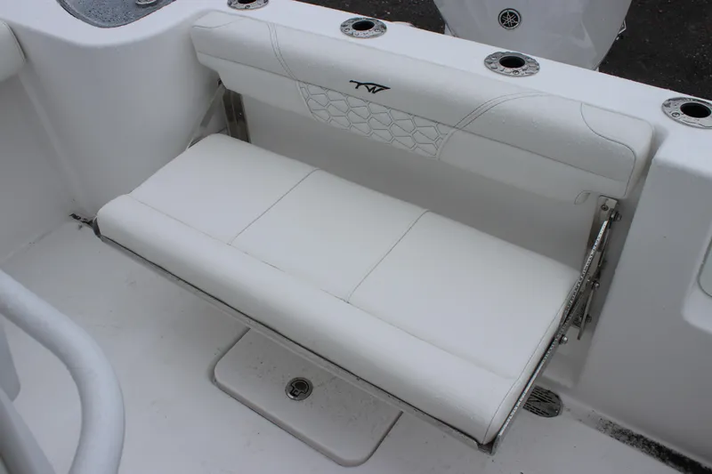 Slide: The Image of 2026 Tidewater 232 LXF boat with white cushioned seating and rod holders. - 11
