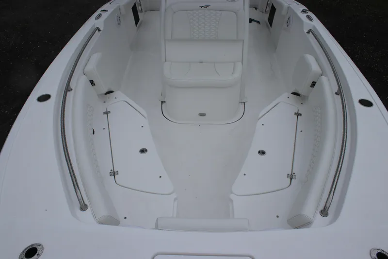 Slide: The Image of 2026 Tidewater 232 LXF boat interior with white seating and storage compartments. - 13