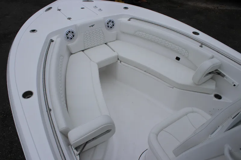 Slide: The Image of 2026 Tidewater 232 LXF boat interior with white seating and speakers. - 14