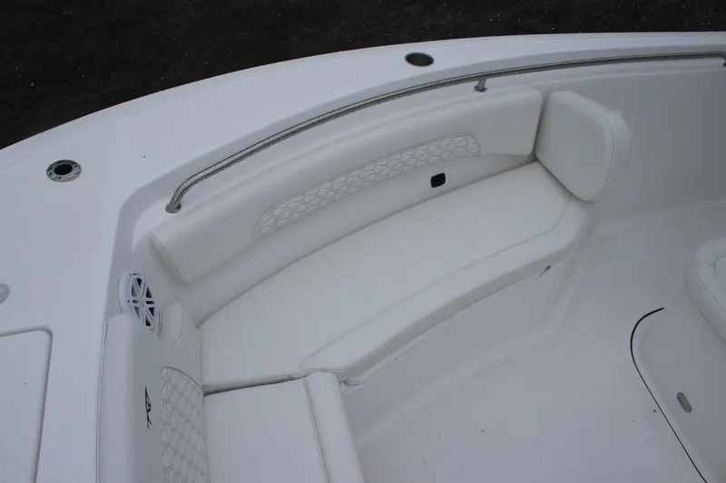 Slide: The Image of 2026 Tidewater 232 LXF boat interior with white cushioned seating and speaker. - 15