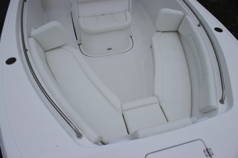 Slide: The Image of 2026 Tidewater 232 LXF boat interior with white cushioned seating. - 16