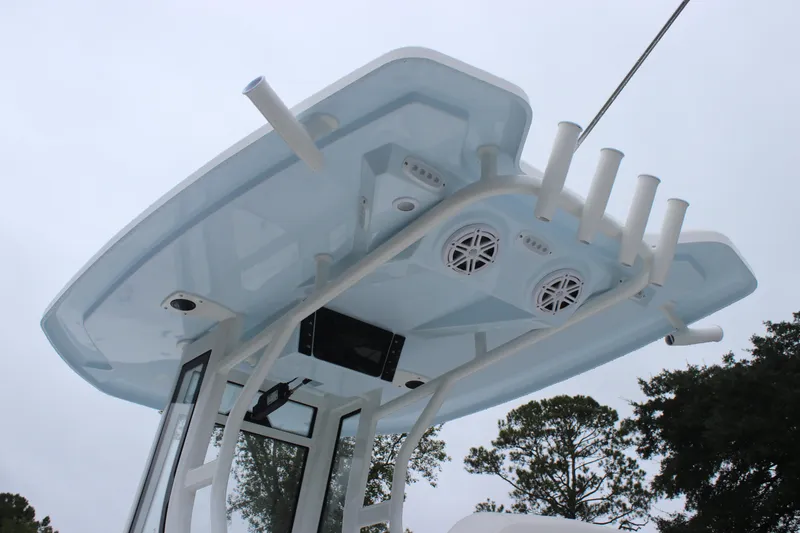 Slide: The Image of 2026 Tidewater 232 LXF boat T-top with rod holders and speakers. - 18