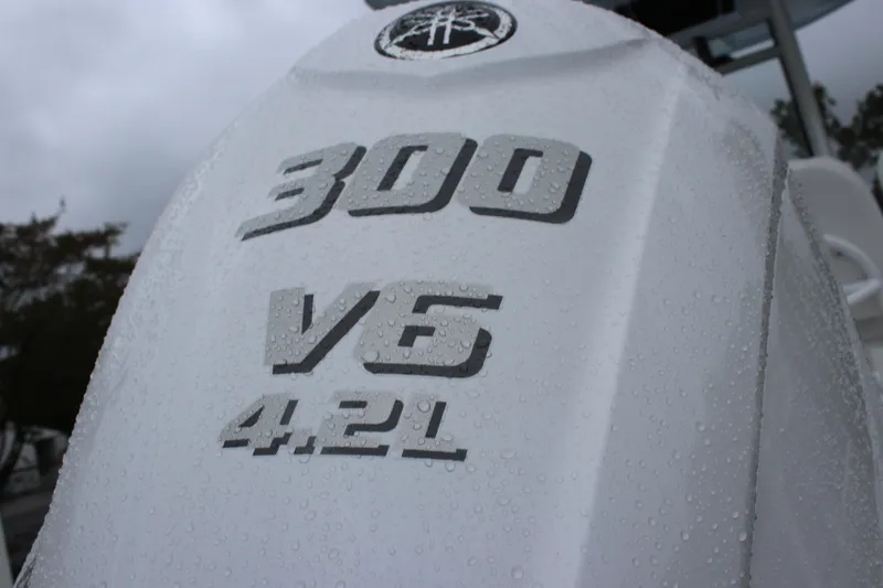 Slide: The Image of Close-up of 2026 Tidewater 232 LXF engine cover with raindrops, featuring 300 V6 4.2L. - 6