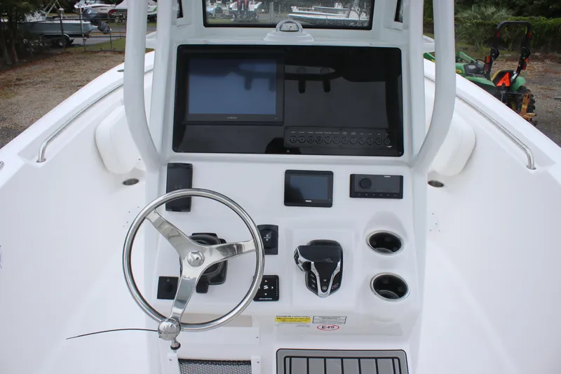 Slide: The Image of 2026 Tidewater 232 LXF boat console with steering wheel and electronic displays. - 7