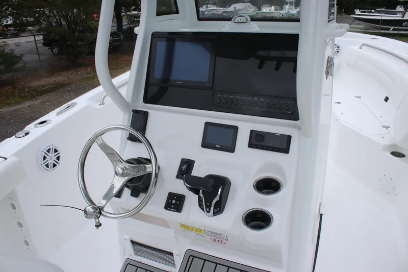Slide: The Image of 2026 Tidewater 232 LXF boat dashboard with steering wheel and electronic controls. - 8
