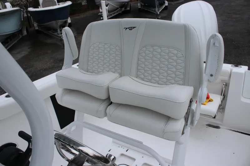 Slide: The Image of 2026 Tidewater 232 LXF boat with luxurious white seating and modern design. - 9