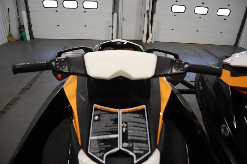Slide: The Image of 2012 Sea-Doo GTR 215 handlebars and dashboard in a garage setting. - 11