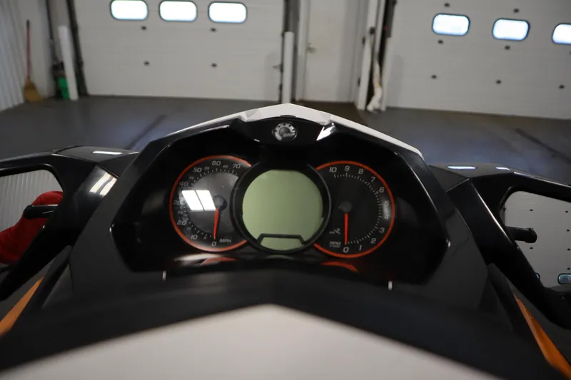 Slide: The Image of 2012 Sea-Doo GTR 215 dashboard with speedometer and tachometer in a garage setting. - 12