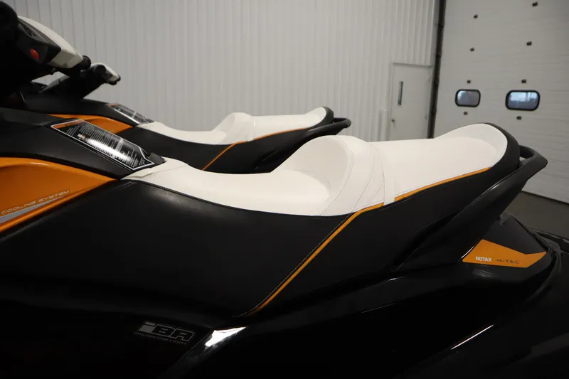 Slide: The Image of 2012 Sea-Doo GTR 215 jet ski with sleek black and orange design in a garage. - 15