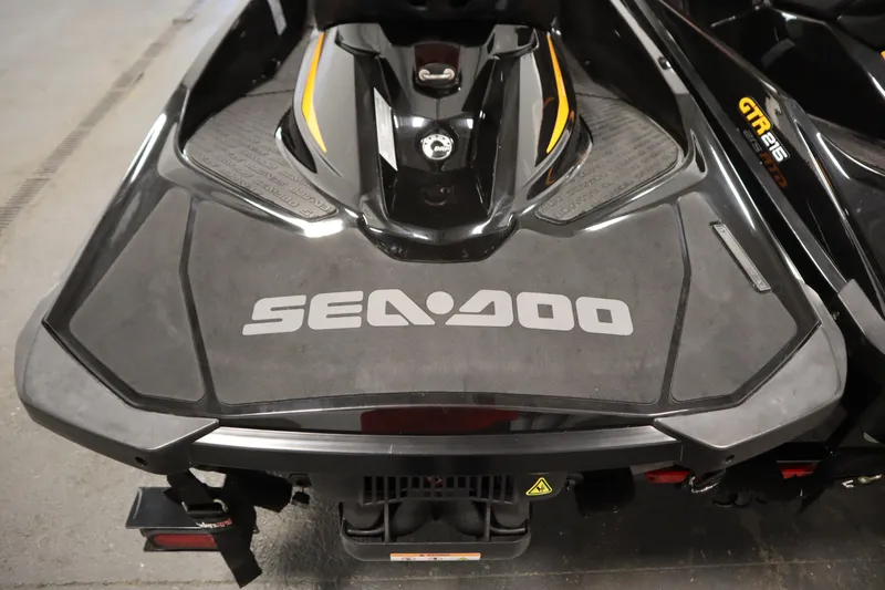 Slide: The Image of 2012 Sea-Doo GTR 215 jet ski, black with yellow accents, rear view. - 18