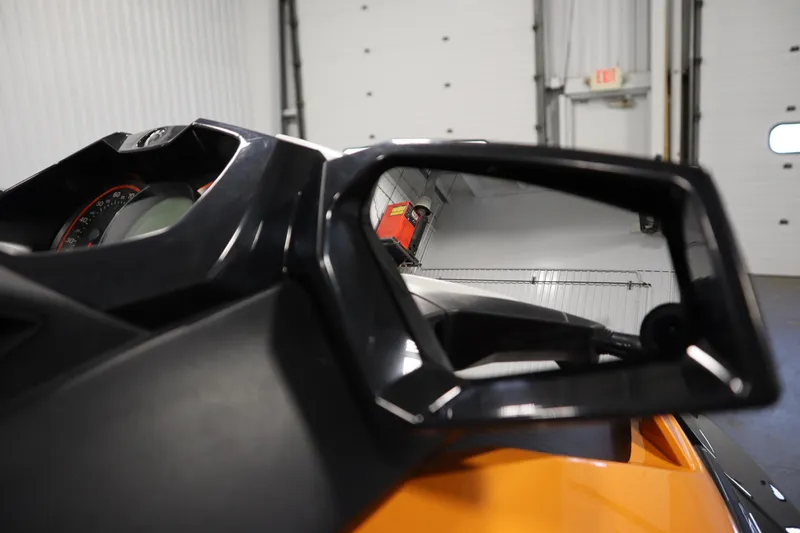 Slide: The Image of Close-up of 2012 Sea-Doo GTR 215 dashboard and mirror in a garage. - 23