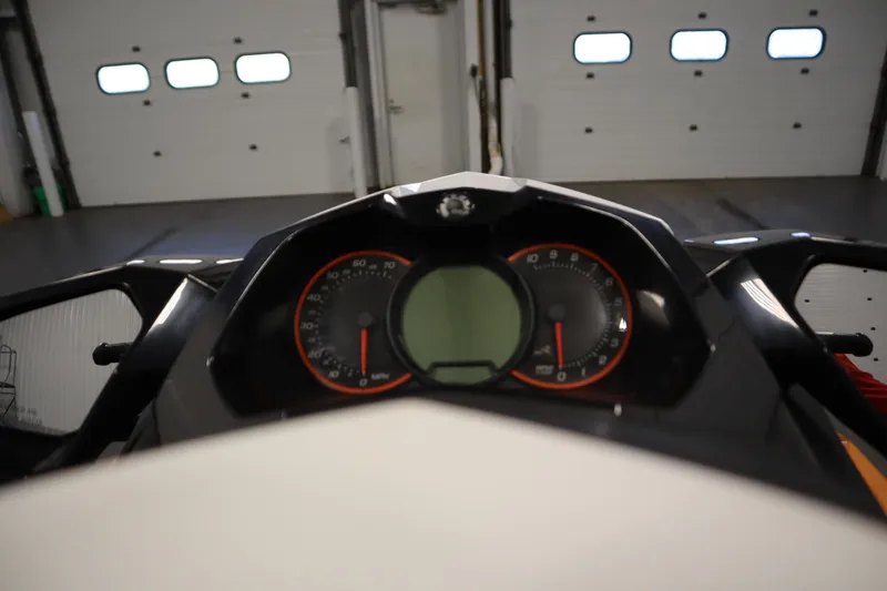 Slide: The Image of 2012 Sea-Doo GTR 215 dashboard with speedometer and digital display in a garage. - 27