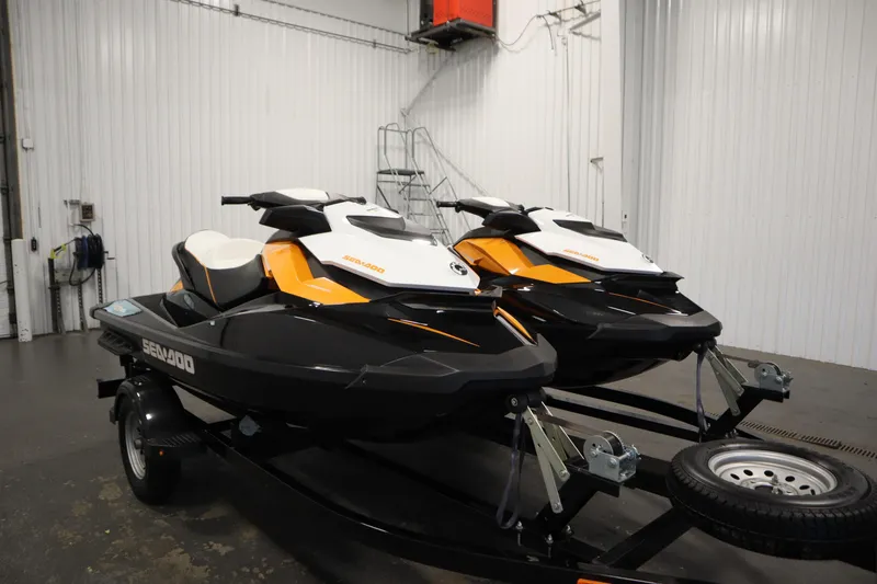 Slide: The Image of 2012 Sea-Doo GTR 215 jet skis on trailer in indoor storage facility. - 3