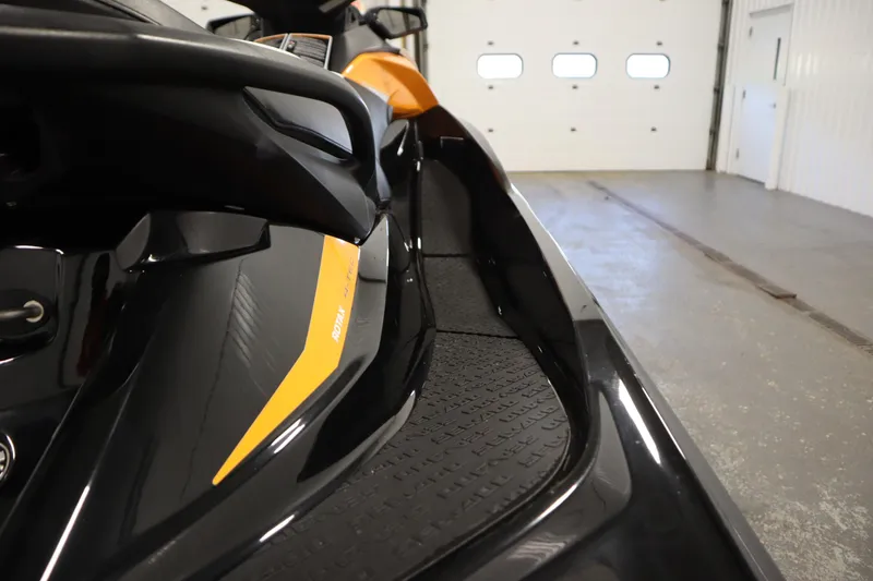 Slide: The Image of 2012 Sea-Doo GTR 215 jet ski, black and yellow, in a garage setting. - 31