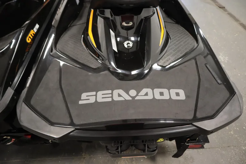 Slide: The Image of 2012 Sea-Doo GTR 215 jet ski, black with yellow accents, rear view. - 33