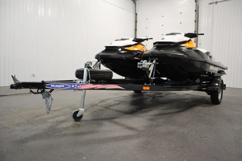 Slide: The Image of 2012 Sea-Doo GTR 215 jet skis on a trailer in a garage setting. - 36