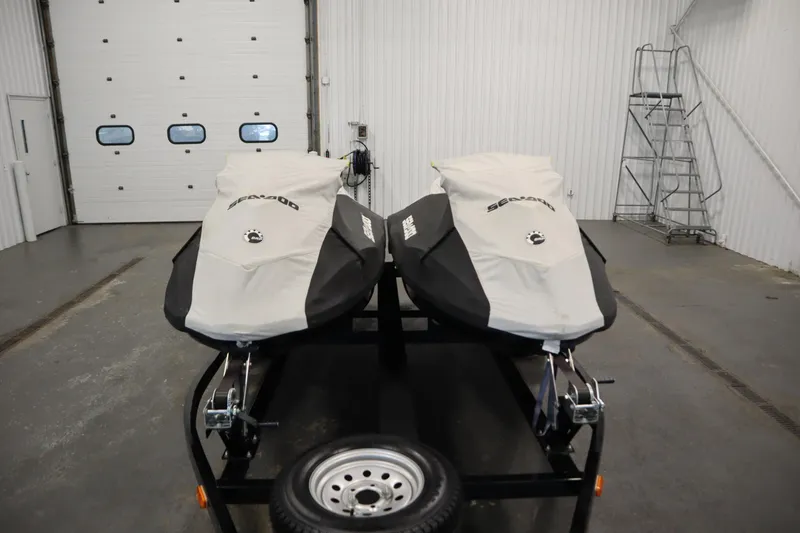 Slide: The Image of Two covered 2012 Sea-Doo GTR 215 jet skis on a trailer in a garage. - 38