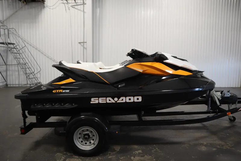 Slide: The Image of 2012 Sea-Doo GTR 215 jet ski on trailer in indoor setting. - 4
