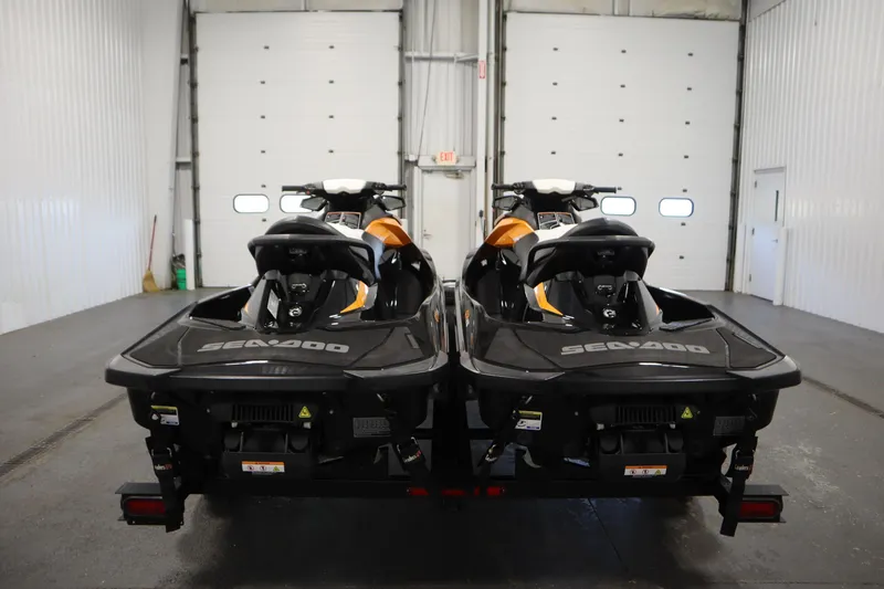 Slide: The Image of 2012 Sea-Doo GTR 215 jet skis on trailer in indoor storage facility. - 6