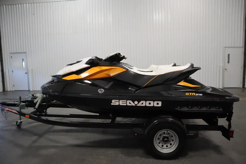 Slide: The Image of 2012 Sea-Doo GTR 215 jet ski on trailer in indoor setting. - 8