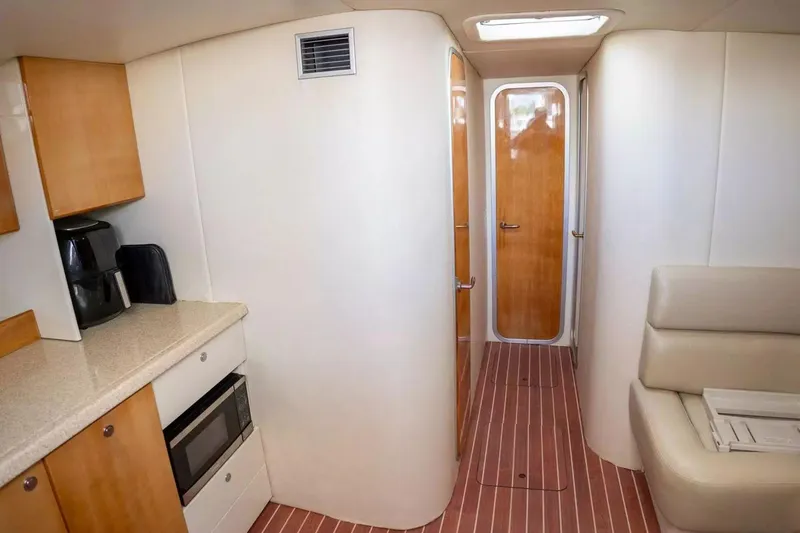 Slide: The Image of Interior of 1999 Cranchi Mediterranee 41 yacht with kitchenette and seating area. - 15
