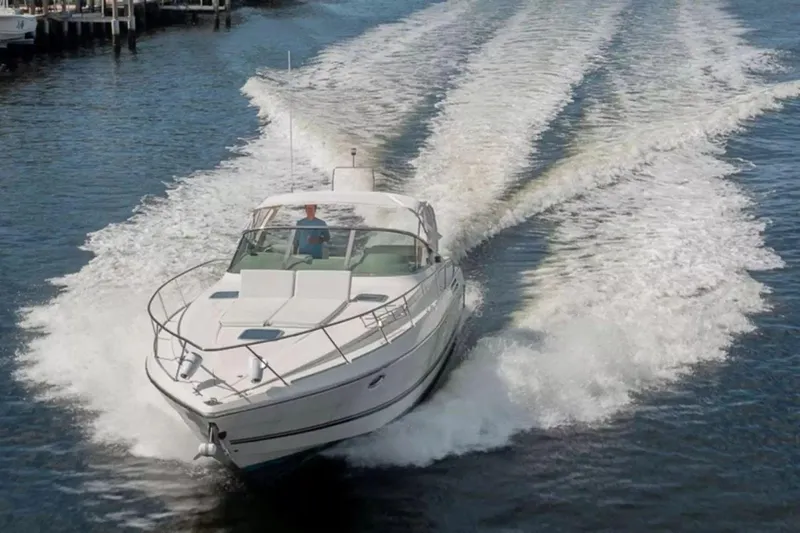 Slide: The Image of 1999 Cranchi Mediterranee 41 yacht cruising on open water, leaving a wake behind. - 4