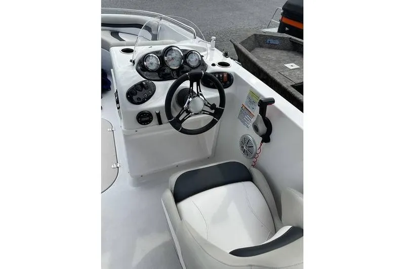 Slide: The Image of 2021 Starcraft 1915 OB Limited boat cockpit with steering wheel and control panel. - 16