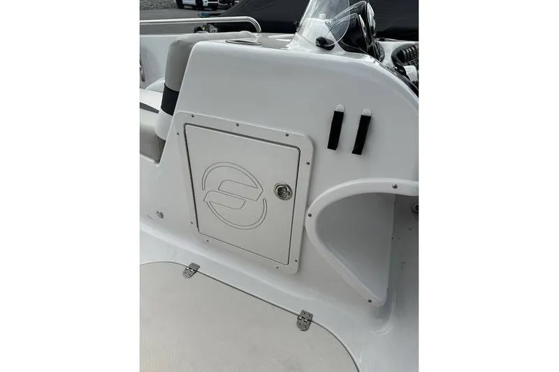 Slide: The Image of 2021 Starcraft 1915 OB Limited boat interior with storage compartment and steering console. - 20
