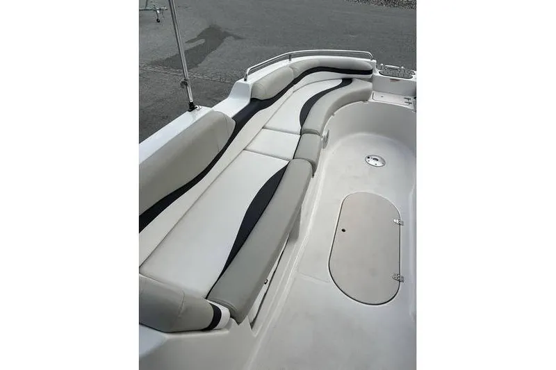 Slide: The Image of 2021 Starcraft 1915 OB Limited boat interior with curved seating and storage hatch. - 22