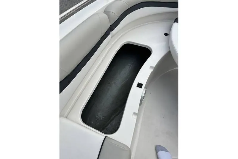 Slide: The Image of 2021 Starcraft 1915 OB Limited boat interior storage compartment with cushioned seating. - 24