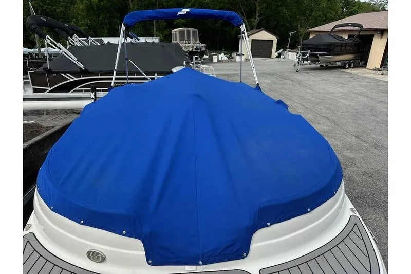 Slide: The Image of 2021 Starcraft 1915 OB Limited boat with blue cover in a marina setting. - 34