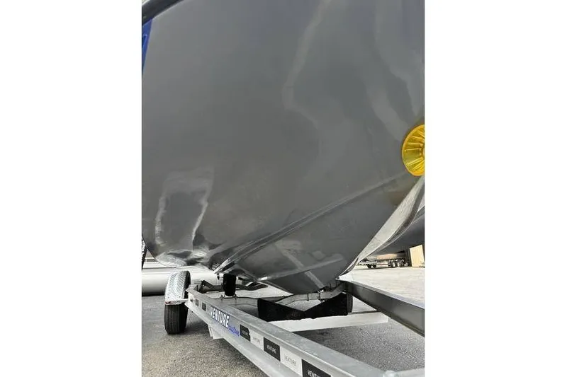 Slide: The Image of 2021 Starcraft 1915 OB Limited boat hull on trailer, close-up view. - 36