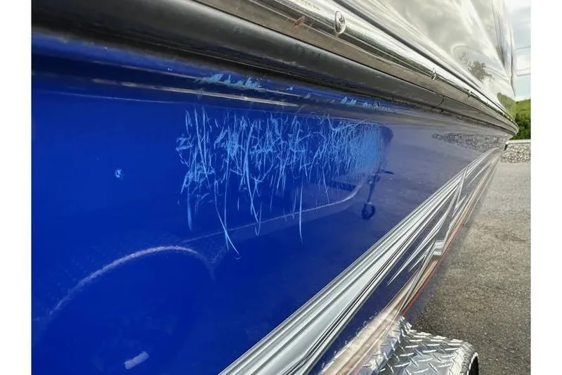 Slide: The Image of 2021 Starcraft 1915 OB Limited boat with visible scratches on blue hull. - 4