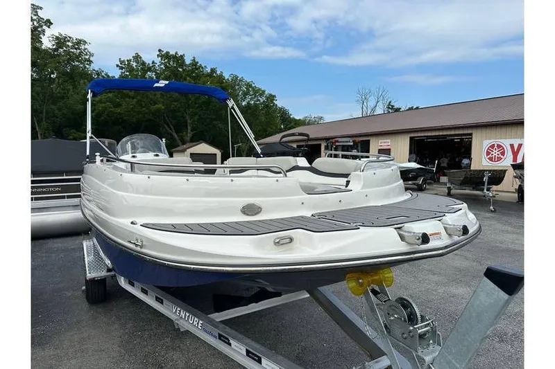 Slide: The Image of 2021 Starcraft 1915 OB Limited boat on trailer, parked outdoors near dealership. - 6