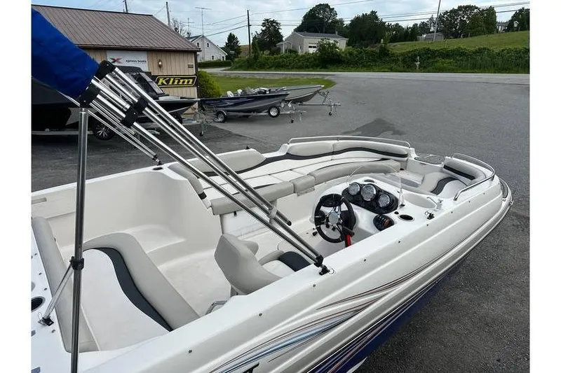 Slide: The Image of 2021 Starcraft 1915 OB Limited boat with seating and steering wheel, parked outdoors. - 8