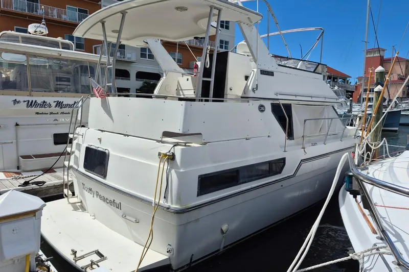 The Image of 1991 Carver 36 Aft Cabin Motor Yacht docked at marina, sunny day. - 1
