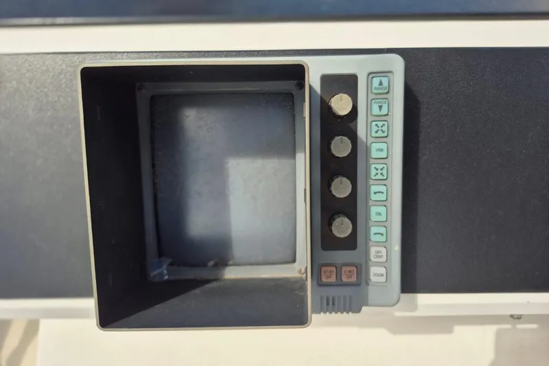 Slide: The Image of Control panel of a 1991 Carver 36 Aft Cabin Motor Yacht, featuring buttons and dials. - 13