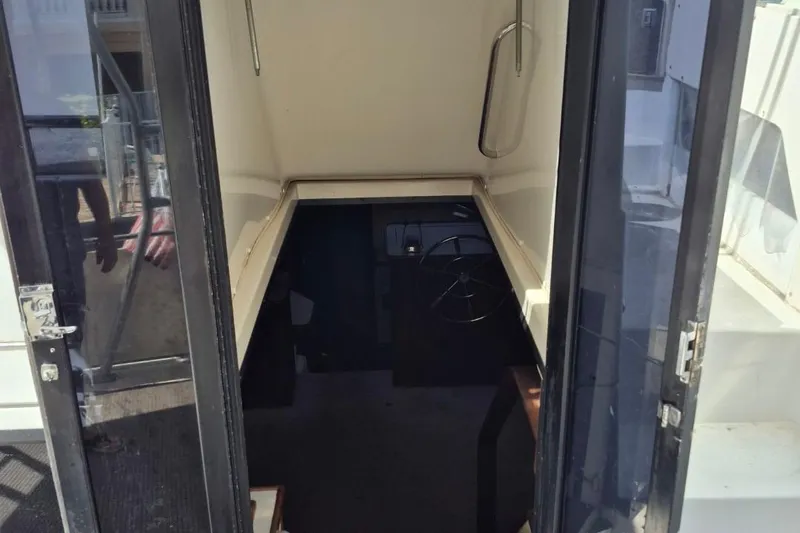 Slide: The Image of 1991 Carver 36 Aft Cabin Motor Yacht interior view with steering wheel. - 15