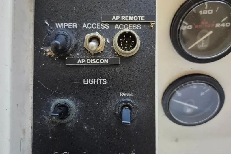 Slide: The Image of Control panel of a 1991 Carver 36 Aft Cabin Motor Yacht with switches and gauges. - 21