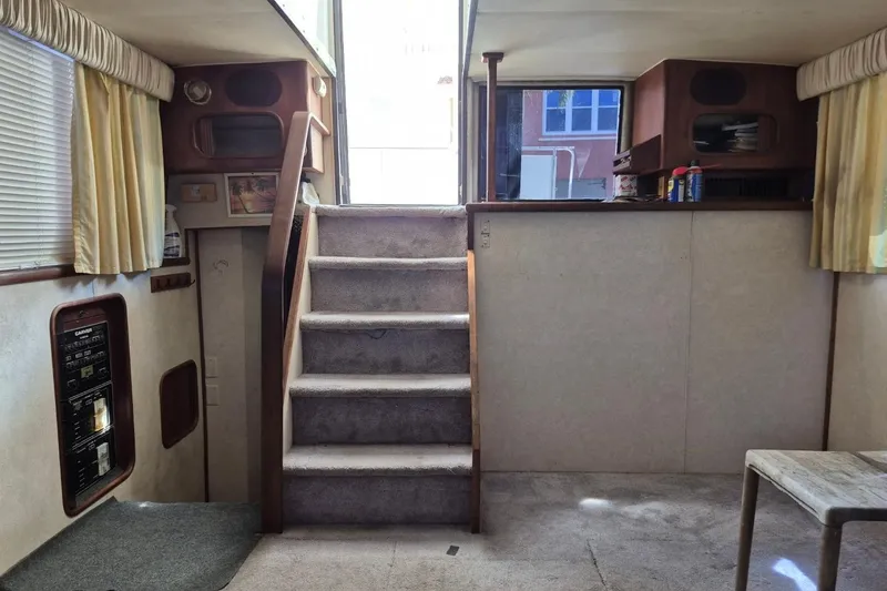 Slide: The Image of Interior of 1991 Carver 36 Aft Cabin Motor Yacht with stairs and cozy decor. - 31