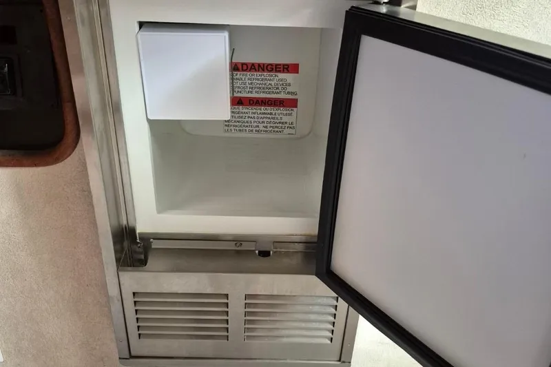 Slide: The Image of Open refrigerator door on 1991 Carver 36 Aft Cabin Motor Yacht, showing interior warning label. - 32