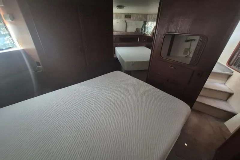 Slide: The Image of 1991 Carver 36 Aft Cabin Motor Yacht interior with cozy bedroom and wooden furnishings. - 36