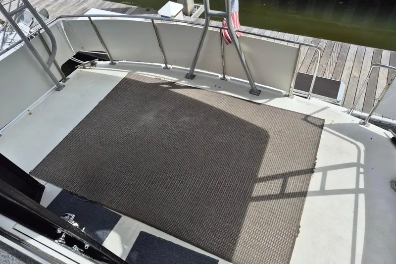 Slide: The Image of 1991 Carver 36 Aft Cabin Motor Yacht deck with railing and carpet. - 44
